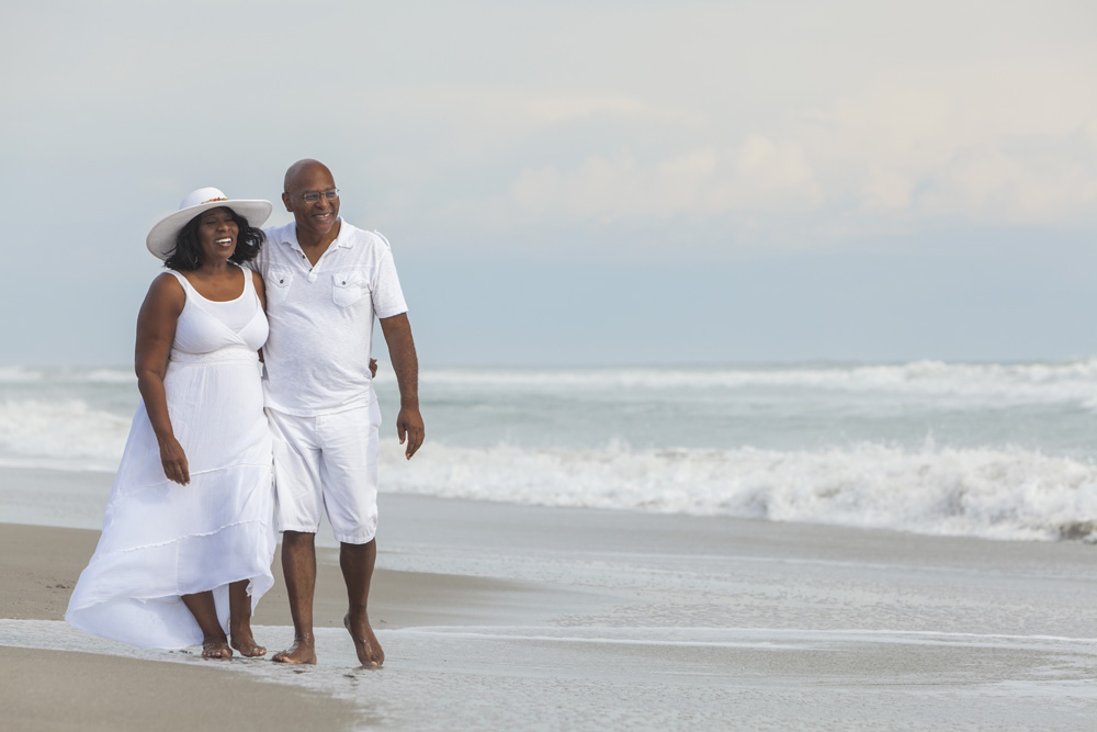 Older couple walking on the beach